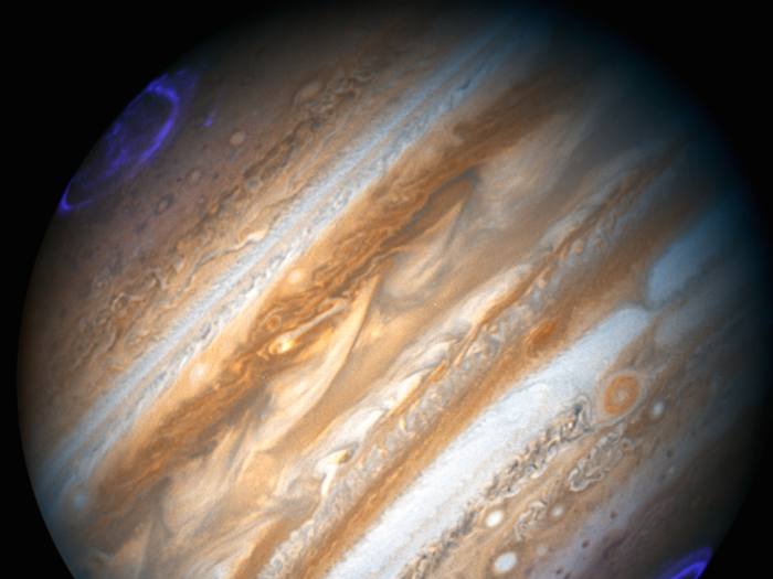 Jupiter has more than 300 times the mass as Earth, so its gravitational pull is stronger.