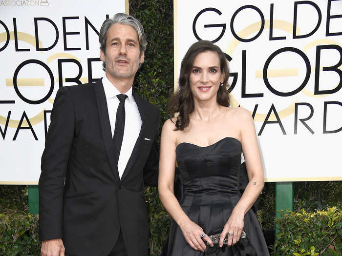 Winona Ryder wore a simple black dress with Scott Mackinlay.