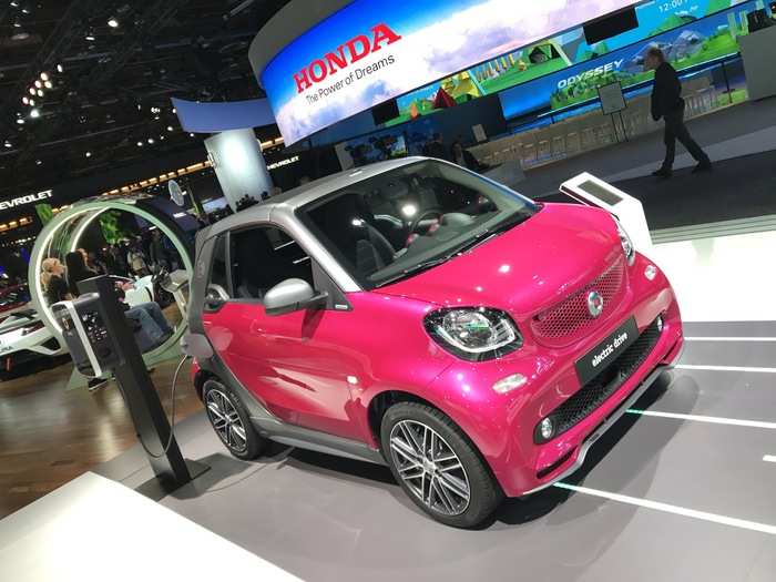 A pink, electric Smart car.