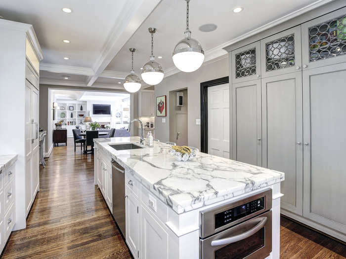 The kitchen is bright and updated, with marble countertops and luxury appliances.