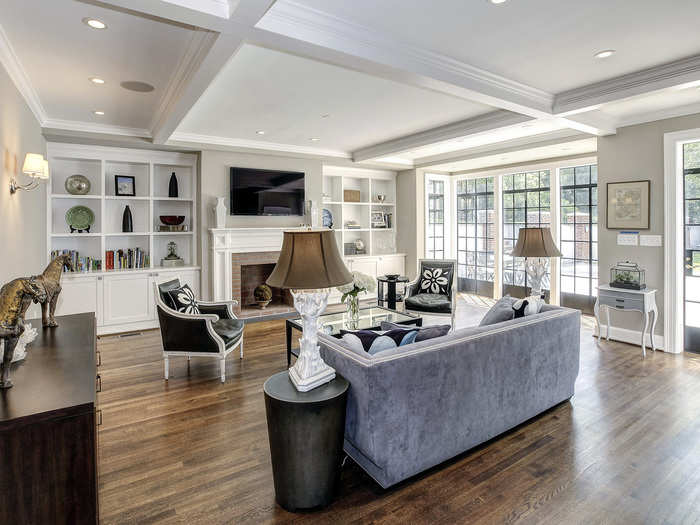 The family room has a wall of sunny windows overlooking the garden out back.