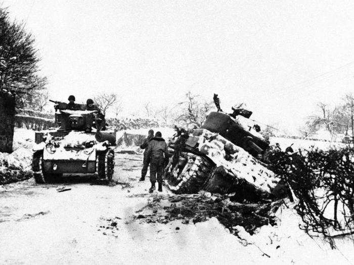 One American tank passes another, bogged down in a ditch at the side of the road in Belgium, January 25, 1945, at one the northern flanks of the von Rundstedt bulge near Amonines. By this point, the bulge had been all but eliminated with surviving Germans retiring behind their Siegfried line, when they began their desperate gamble.