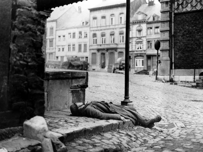 A dead German soldier, killed during the German counter offensive in the Belgium-Luxembourg salient, on a street corner in Stavelot, Belgium, on January 2, 1945.