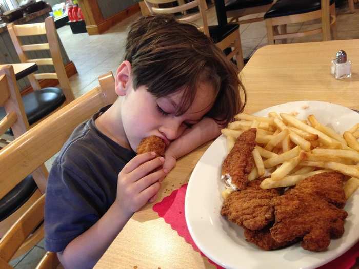My son Dante had endured a long, rough day. He conked out over a plate of chicken tenders and fries.
