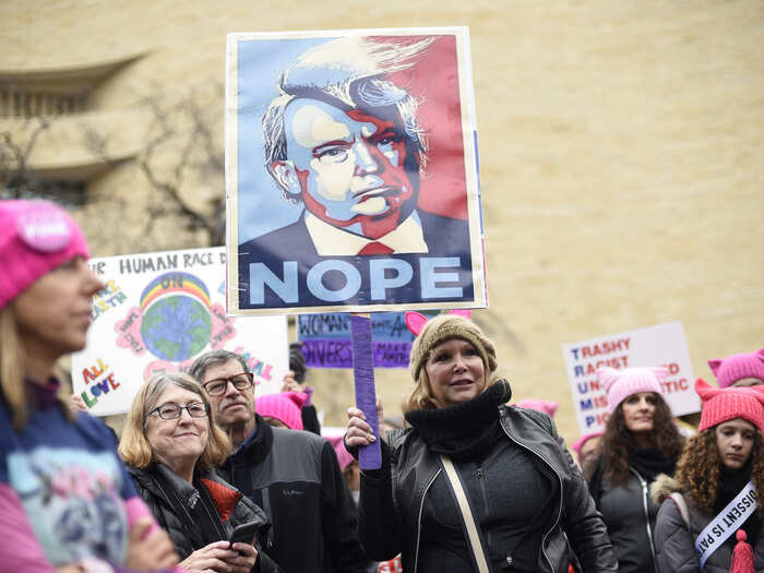 This woman held a sign that imitated the Barack Obama "Hope" poster, designed by artist Shepard Fairey, which came to represent his run for the presidency in 2008.