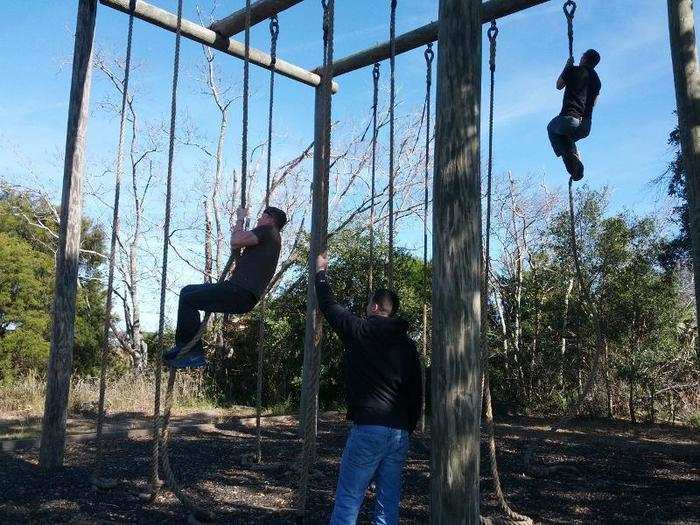 Outside I climb the rope at the end of the obstacle course, for old time