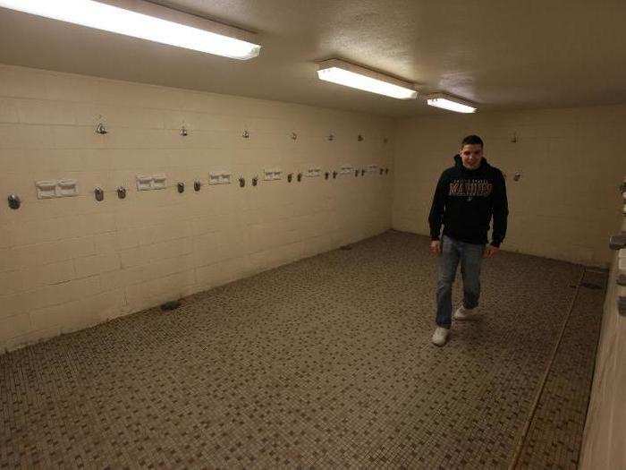 Showers are community — my little brother for scale.