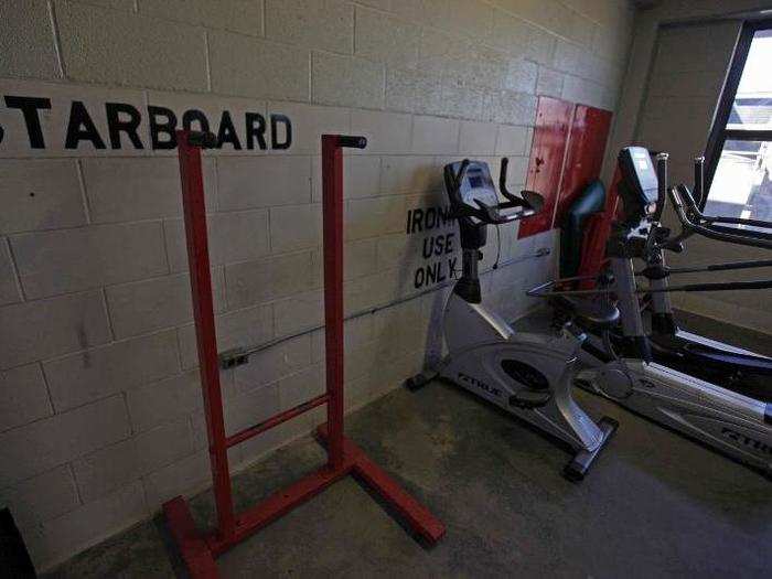 Further toward the front of the bay is the quarterdeck, part of which is set aside for a small "gym."