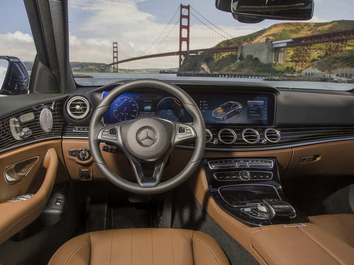 The E-Class offers 64 interior ambient lighting options. The front console comes with a wireless charging dock and a 12.3-inch infotainment touchscreen that can take voice commands.