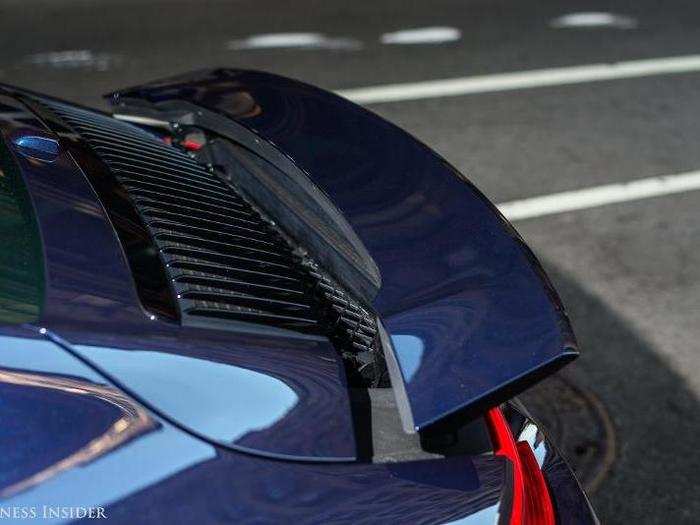 The rear spoiler can be extended and retracted manually, and it will also automatically extend at higher speeds. The idea is to improve downforce and handling, but you probably won