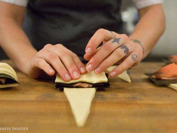 Then we were ready to roll. Dunn picked up the widest part of the pastry and folded it over itself, careful to keep the pointed end centered so the croissant would bake evenly.