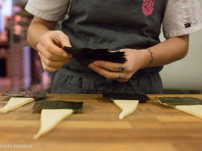 The dough is made by hand over the course of three days. "It takes a lot of butter — very, very good butter," Dunn said, laying down a sheet of seaweed.