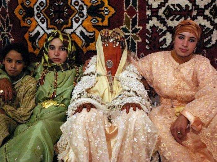 The Moroccan bride puts on a show with three wardrobe changes. For the reception, she trades a white kaftan, or robe, for an outfit that reflects the culture of her family