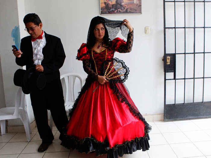 In the highlands above Lima, Peru, traditional brides make quite a splash in red and black gowns, made bigger by multiple layers of heavily embroidered cotton petticoats.