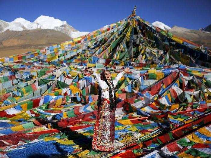 The day before a Tibetan wedding, the groom gives his bride a wedding gown and jewelry, which may include a headdress, silver pieces that attach to her braids, or an amulet that contains a small metal statue of the Buddha.