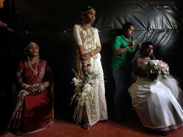 The Sri Lankan bride blends Eastern and Western traditions, donning heavily embroidered silk saris and European-looking veils. Her jewelry includes an uneven number of gemstones, as odd numbers are considered auspicious.