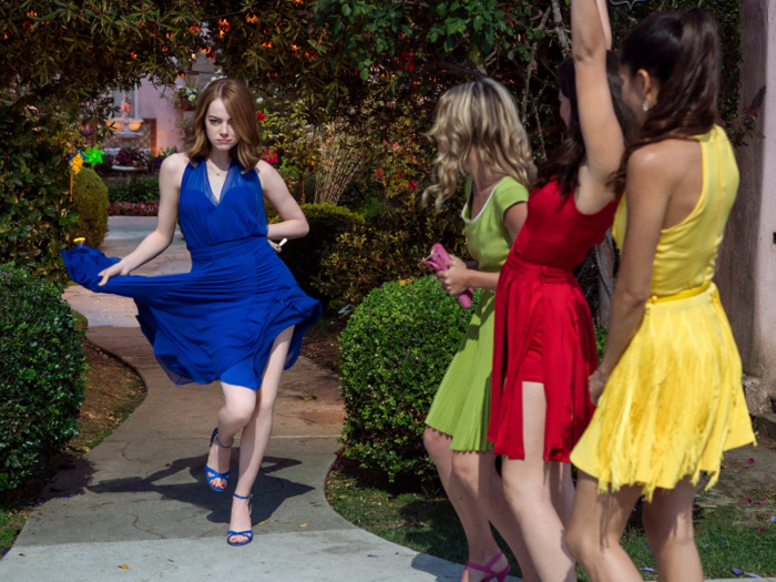 ... and Emma Stone dances in the streets of Los Angeles with her colorful roommates after she fails several acting auditions.