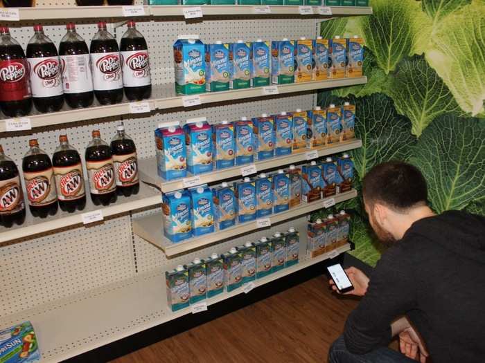 Selecting and scanning the right item fast is harder than it looks. The Garden keeps at least six different varieties of almond milk in stock.