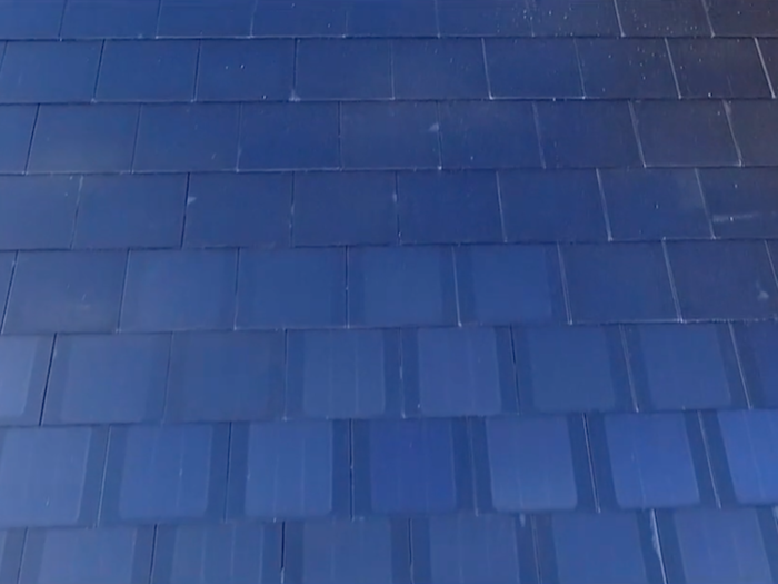 Unlike the textured glass tile and French slate offering, the smooth glass tile seen here was purposefully designed so you could see the solar cells from certain angles.