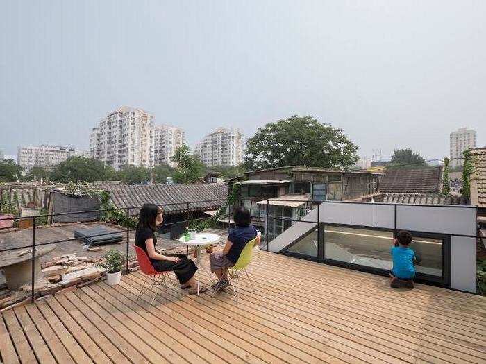 Steps on the side of the house lead to a roof deck.