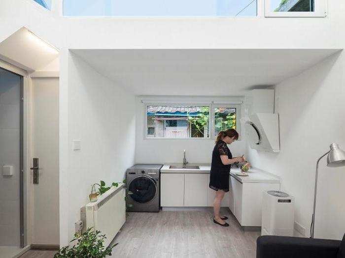 It features a kitchen that connects to a living room, two small bedrooms, and a bathroom.