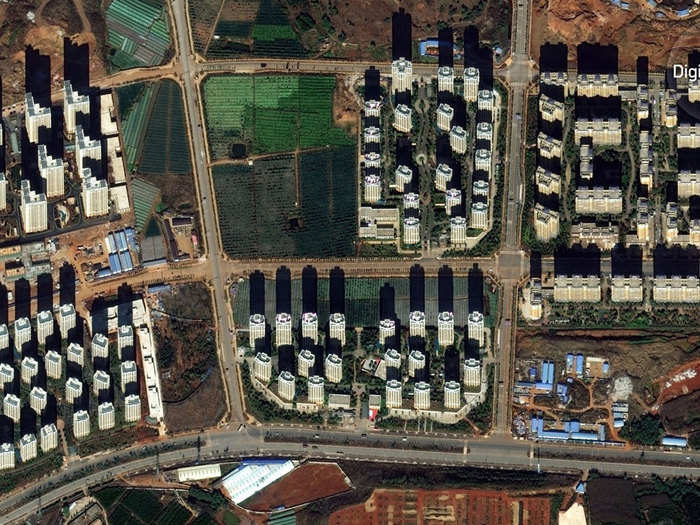 A closer look at some of Chenggong’s mostly vacant skyscrapers. Note the paved road that transitions to dirt as it moves to the left.