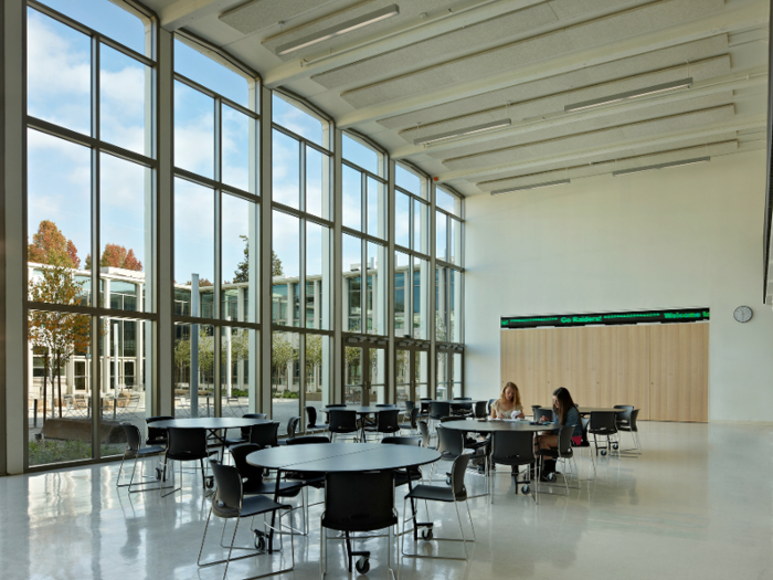 Sleek glass facades and high ceilings give the school a fresh, minimalist feel.