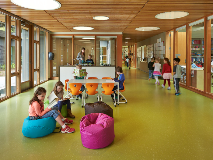 Contrast that with its playful, colorful interior where kids roam on green floors and plop down in beanbag chairs.