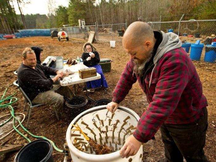 In Warrenton, North Carolina, Mike Holland (right) oversees a sort of preppers commune. He lives on the 13-acre property with his wife, four children, and three other men.