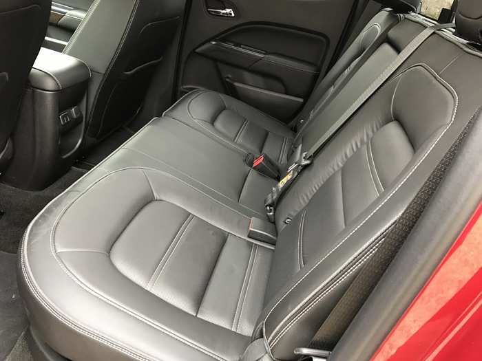 The rear seats of the Canyon Denali are comfy, leather, and a bench design.