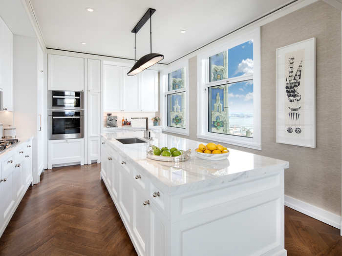 The condos have solid oak herringbone floors and marble countertops in the kitchen.