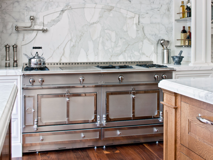 Elegant features include a Christopher Peacock-designed kitchen adorned in marble.