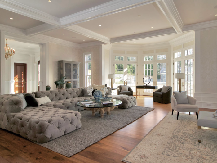 In the living room, the focal point is this large low-back sofa and coffee table, with a small area created near the fireplace.