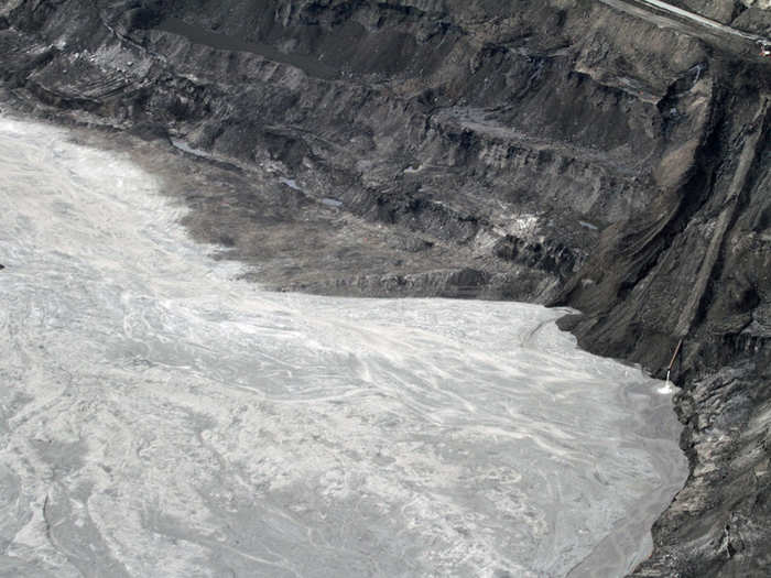 The sand and water mixture in the middle is pumped to open storage areas called tailings ponds.