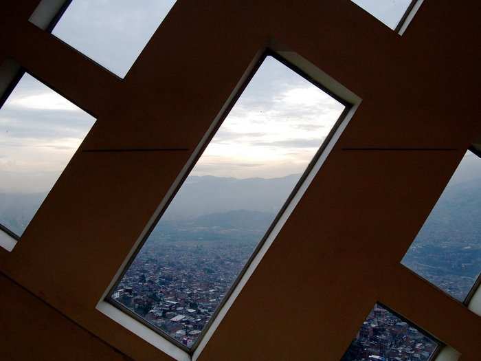 From inside the library, in the Santo Domingo Savio neighborhood, the view is of Medellín itself, in a valley surrounded by the Andes.