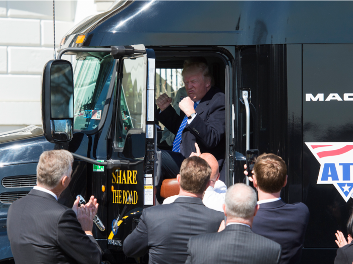 Trump meets with truckers and CEOs at the White House and sits in the front seat of a Mack Truck.