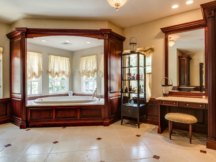 The ensuite bathroom is covered in mahogany furniture. The main feature, a whirlpool tub, is encased in a mahogany "throne," according to the listing.