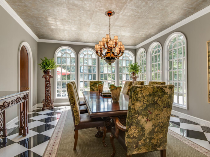 Another door from the kitchen leads into a large formal dining room. The design feels a lot like the main entrance hall.