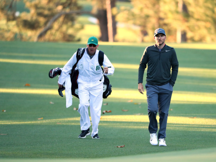 Players are allowed to use their own caddies now, but they have to wear the Augusta uniform — green hat, white jumpsuit.