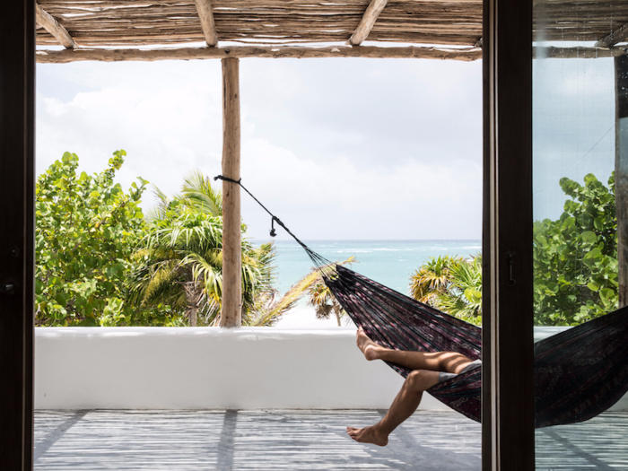 The rooms have floor-to-ceiling windows that overlook the beach and the garden behind. Some also have balconies.