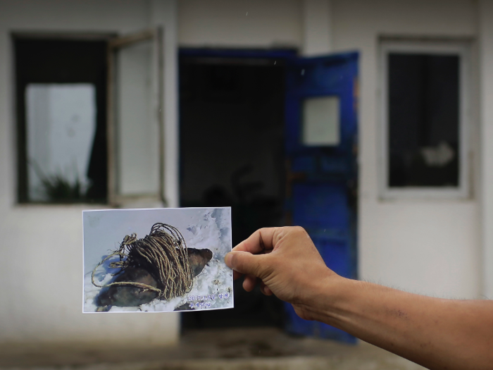 Former bomb squad member Jong Il Hyon, 44, has this photo of an unexploded bomb his team found near the railway running from Hamhung from Pyongyang.