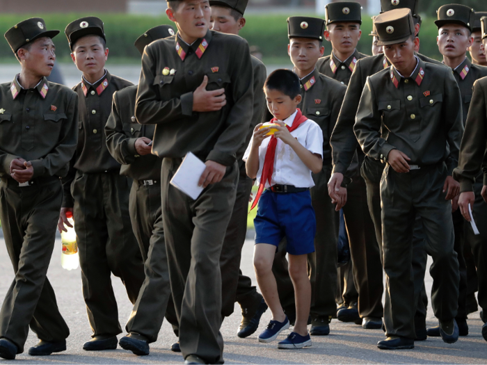 At school, North Korean children are taught patriotic songs, salute portraits of current leader Kim Jong-Un, and study the life of former leader Kim Il-Sung closely.