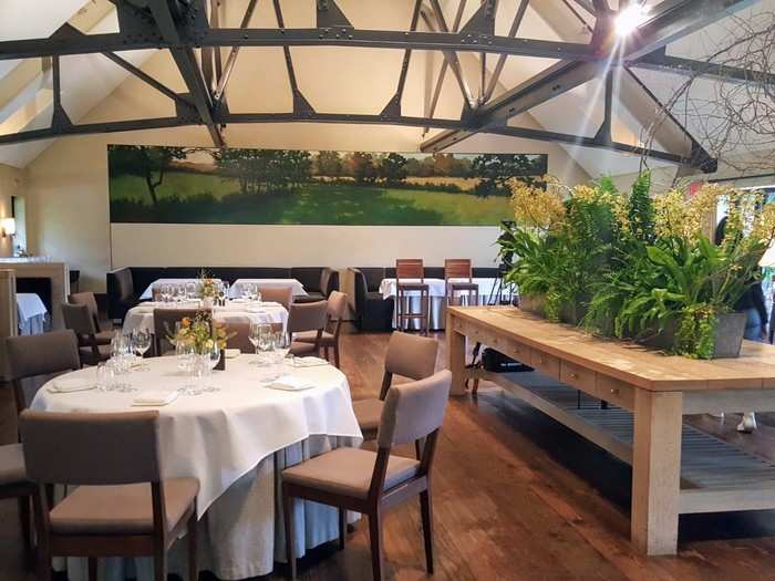 Inside we go for the main event. The bright dining room was filled with flowers, metal beams, and white tablecloths. Back when the building was used for the farm, this space used to be the milking barn.