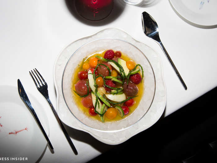 Raw items like this chilled gazpacho salad appetizer are served in ice-filled, Georg Jensen bowls. This salad comes with lemon cucumbers, tristar strawberries, and seabeans.