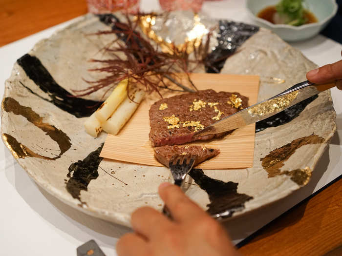 The Wagyu steak is sprinkled with gold flakes and served with white asparagus and a ponzu sauce. "The gold is more for show, it doesn