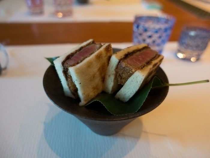 Dinner includes about 10 courses, and the menu changes daily. One dish is the tonkatsu sandwich, which consists of a breaded, deep-fried pork cutlet prepared in a demi-glace.