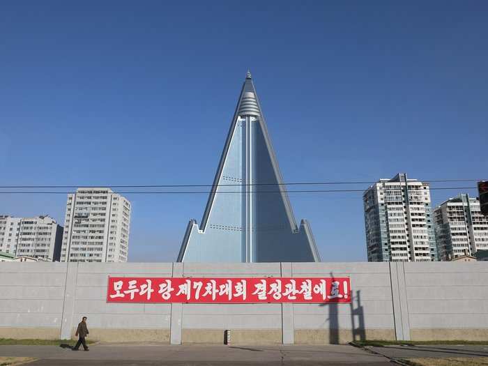 Until suddenly, in July, something happened to the sign below which reads: "Everybody do it in accordance with the decisions achieved at the 7th Party Congress!"