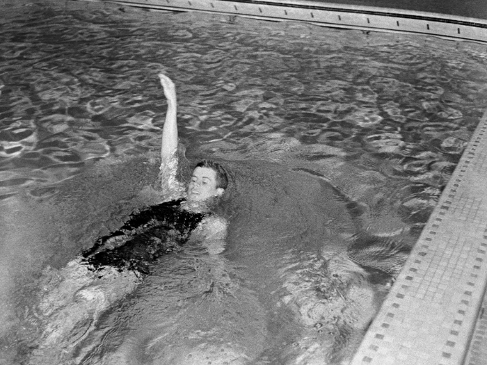 John F. Kennedy swimming in the backstroke event for the varsity swimming team at Harvard, where he was a student, 1938.