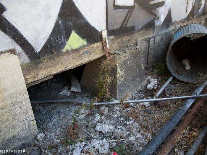 Channeling my inner urban explorer, I searched the boarded-up building for an entrance and found it. Alas, I was not appropriately dressed (and far too chicken) to crawl inside.