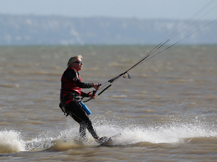 In 2009, he kite-surfed with a naked model on his back. In February, he hit the waves to compete against former US President Barack Obama.